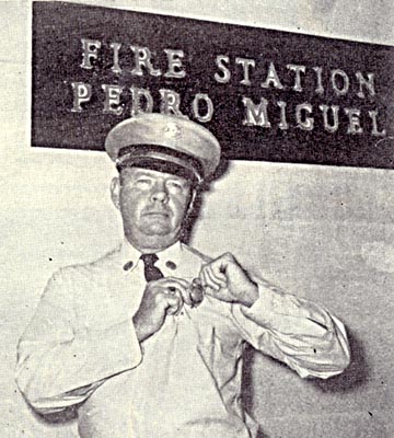 Canal Zone Fire Department Lieutenant putting on his badge